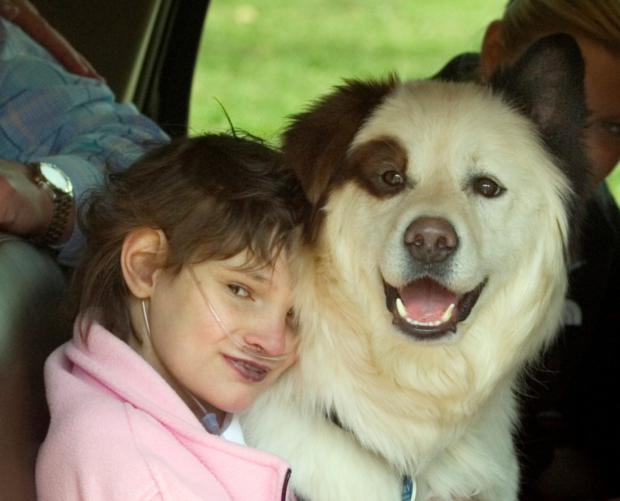 A Granted wish child smiling with a beloved dog