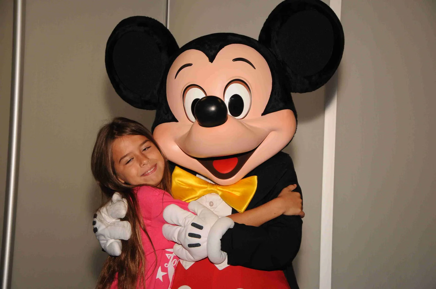 A Granted wish child hugging Mickey Mouse